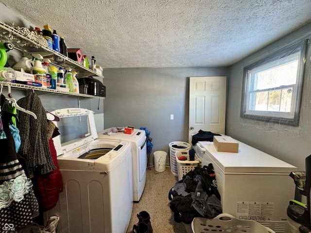 washroom with carpet floors, laundry area, washing machine and dryer, and a textured ceiling