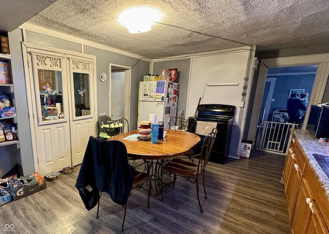 dining space with a textured ceiling and dark wood-type flooring