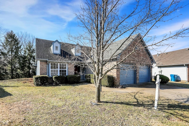 new england style home with an attached garage, a front yard, concrete driveway, and brick siding