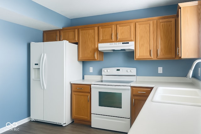 254 Halldale Dr, Whiteland, IN 46184 - kitchen featuring white appliances, under cabinet range hood, dark wood finished floors, light countertops, and brown cabinetry