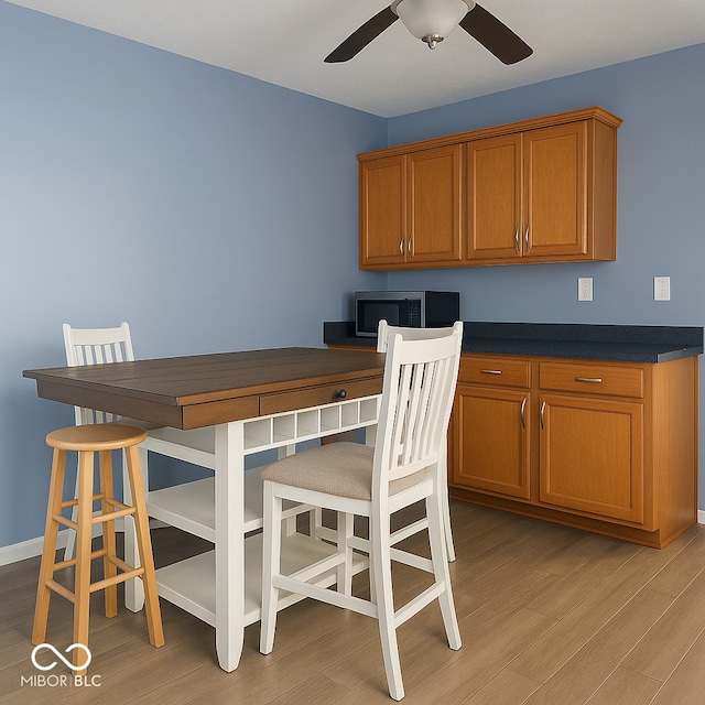 254 Halldale Dr, Whiteland, IN 46184 - dining room featuring light wood-type flooring, a ceiling fan, and built in desk