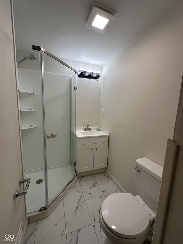 full bathroom with a stall shower, baseboards, toilet, marble finish floor, and vanity