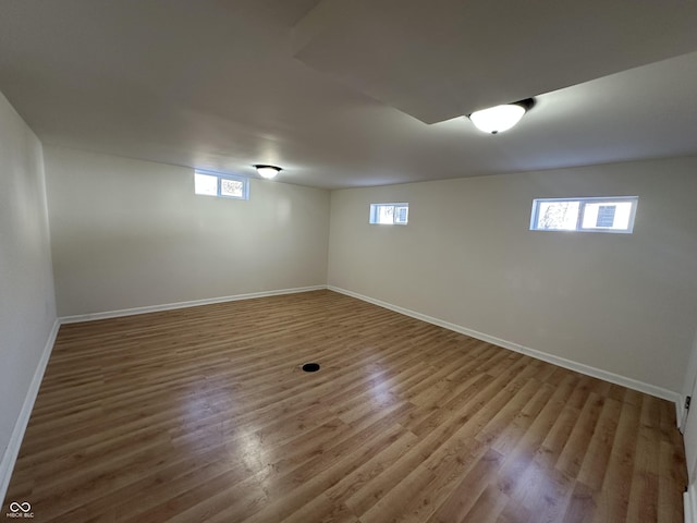 basement featuring baseboards and wood finished floors