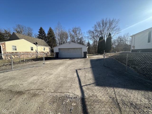 view of side of property with a garage, an outdoor structure, and fence