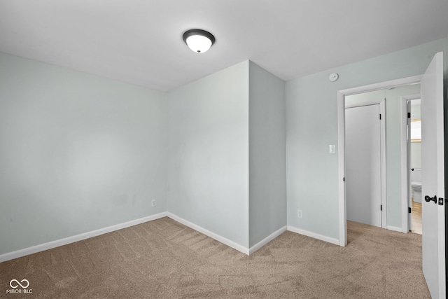 carpeted empty room with baseboards