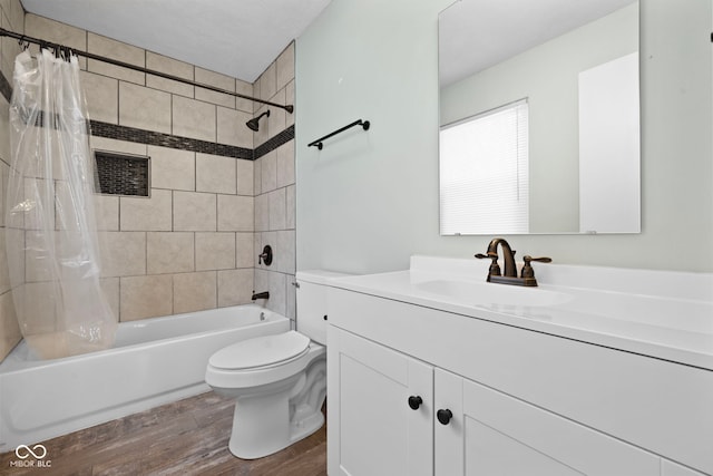 full bathroom featuring vanity, shower / bathtub combination with curtain, toilet, and wood finished floors