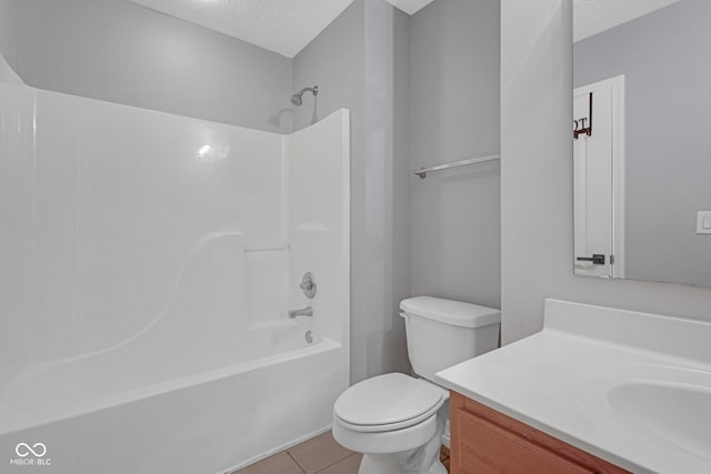 full bathroom with toilet, tile patterned floors, a textured ceiling, vanity, and shower / washtub combination