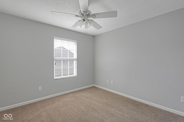 empty room featuring carpet floors, a textured ceiling, baseboards, and a ceiling fan