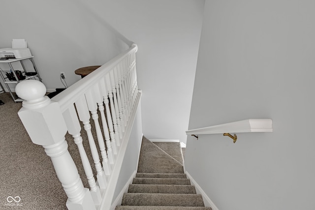 staircase with carpet floors and baseboards