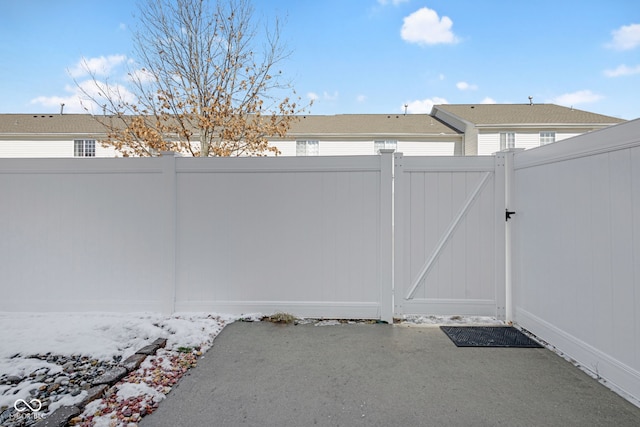 view of gate featuring a patio area and fence