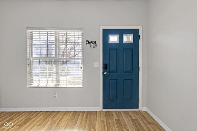 entryway featuring baseboards and wood finished floors