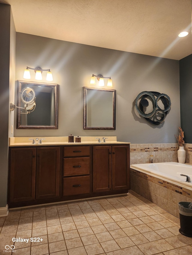 full bath featuring double vanity, tile patterned flooring, and a sink