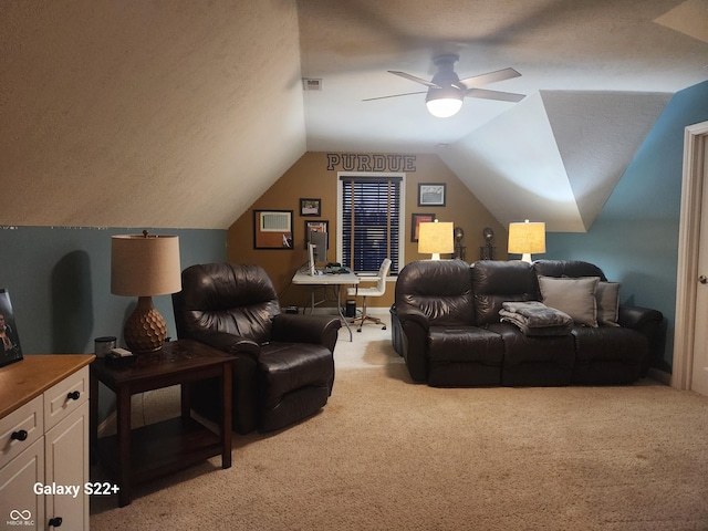 home theater with visible vents, light carpet, vaulted ceiling, a textured ceiling, and ceiling fan