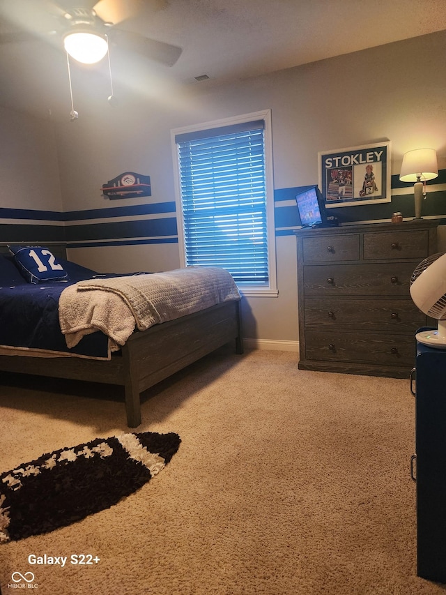 bedroom with ceiling fan, carpet, and baseboards