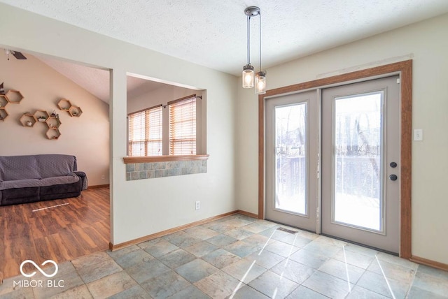 entryway featuring a textured ceiling, visible vents, and baseboards