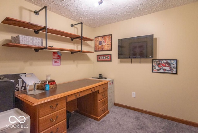 carpeted home office with a textured ceiling and baseboards