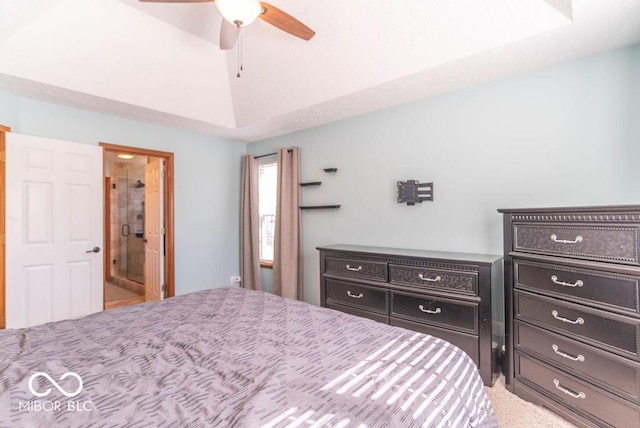 bedroom featuring lofted ceiling, ceiling fan, and connected bathroom