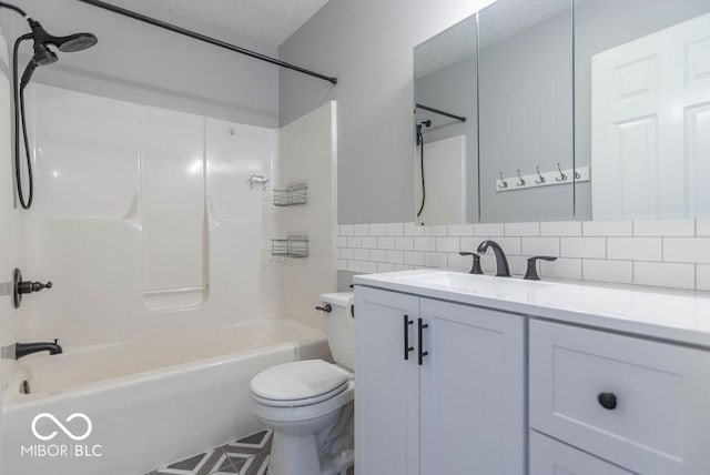 bathroom featuring decorative backsplash, toilet, a textured ceiling, vanity, and shower / bathing tub combination