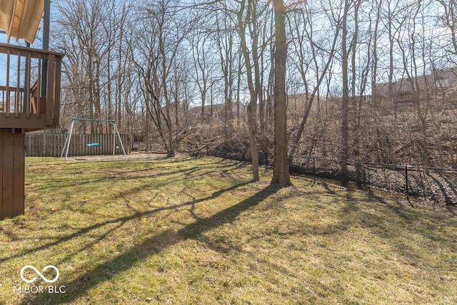 view of yard with a fenced backyard and a playground