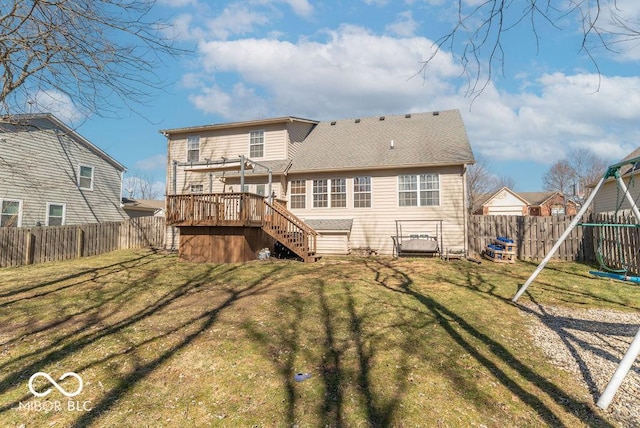 rear view of house featuring a fenced backyard, a yard, and stairway