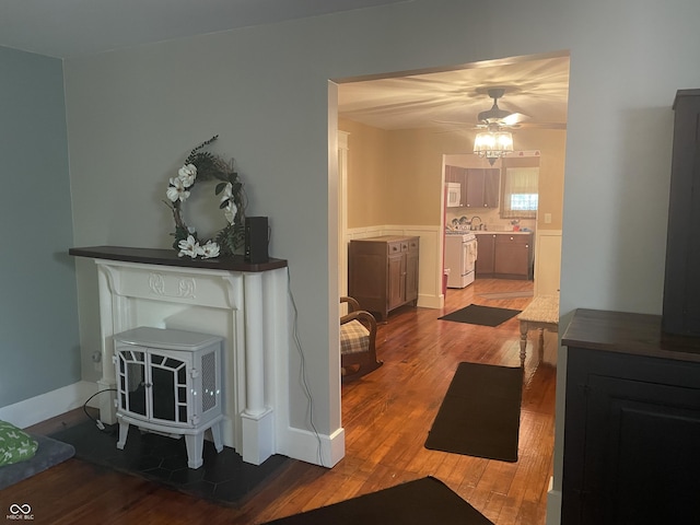 5533 Wilson Way, Jamestown, IN 46147 - living area with wood finished floors, ceiling fan, and a wood stove