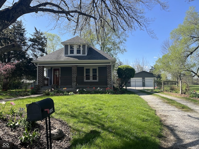 5533 Wilson Way, Jamestown, IN 46147 - bungalow-style house with an outdoor structure, a porch, a front yard, a shingled roof, and a detached garage