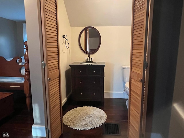 5533 Wilson Way, Jamestown, IN 46147 - bathroom with toilet, baseboards, vanity, vaulted ceiling, and wood finished floors