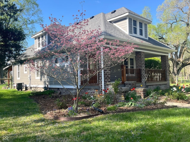 5533 Wilson Way, Jamestown, IN 46147 - view of front facade with a porch, a front yard, a shingled roof, and central air condition unit