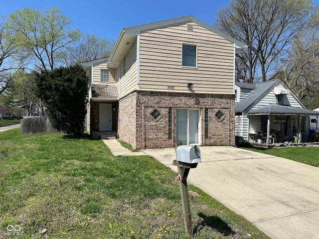 traditional home featuring brick siding, fence, and a front lawn
