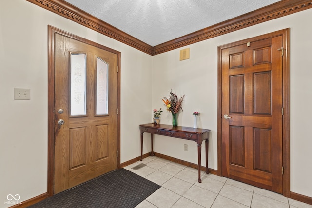 entrance foyer with visible vents, a textured ceiling, baseboards, and light tile patterned floors