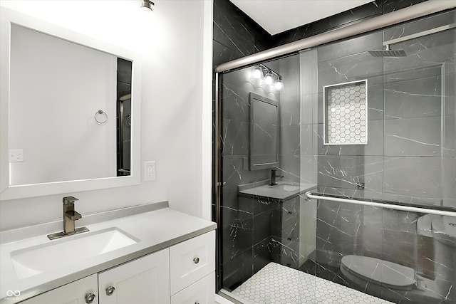 bathroom featuring a stall shower, vanity, and toilet