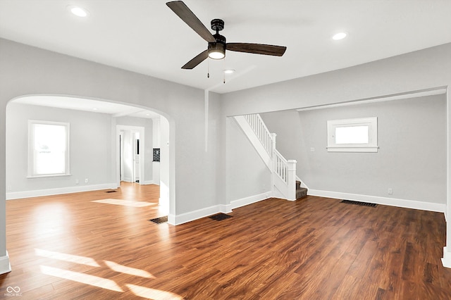 interior space with arched walkways, recessed lighting, visible vents, wood finished floors, and baseboards