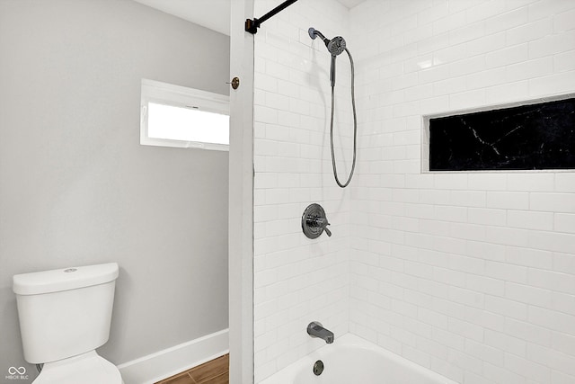 full bathroom with toilet, shower / tub combination, baseboards, and wood finished floors