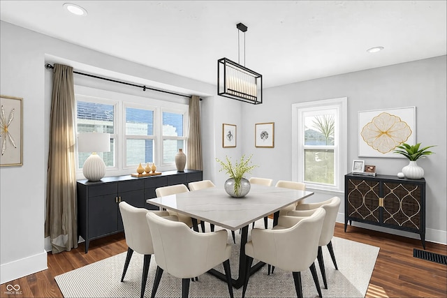 dining room featuring baseboards, visible vents, dark wood finished floors, and recessed lighting