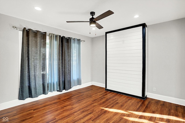 spare room with recessed lighting, baseboards, and wood finished floors