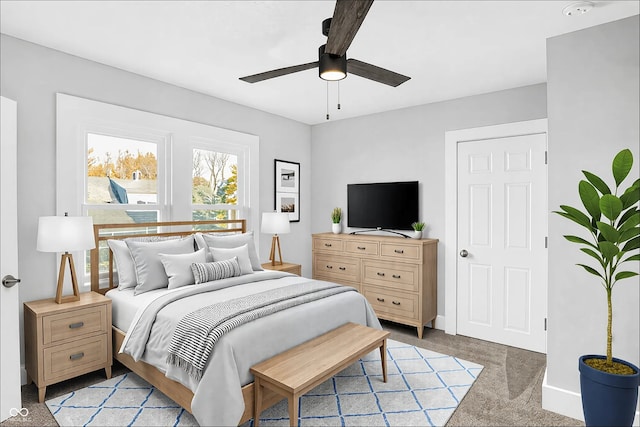 bedroom featuring baseboards, a ceiling fan, and light colored carpet