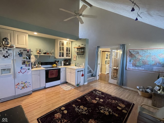 kitchen with electric range, open shelves, white fridge with ice dispenser, light wood finished floors, and ceiling fan