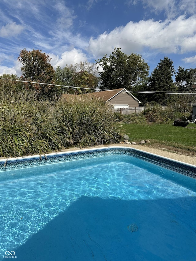 view of swimming pool with a fenced in pool and fence