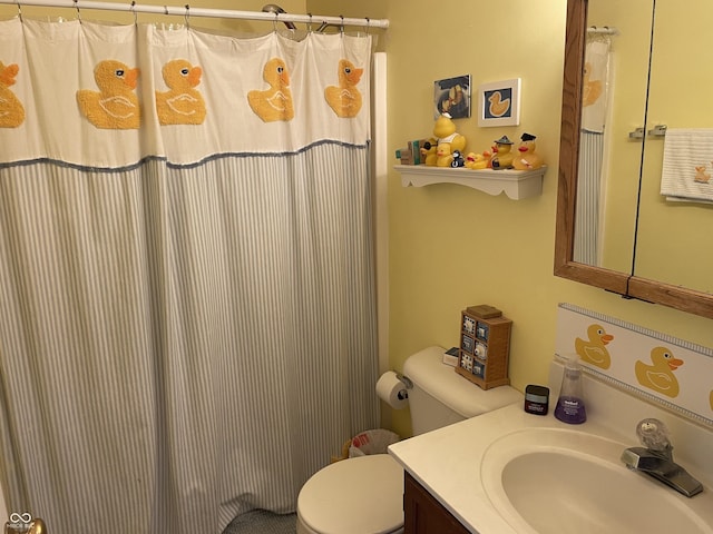 full bathroom with toilet, vanity, and a shower with curtain