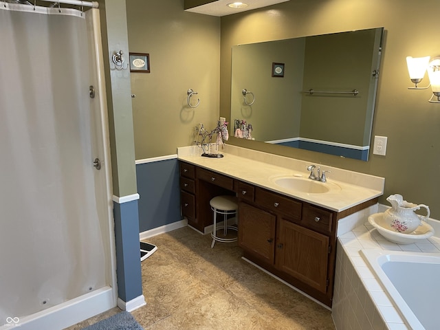 bathroom featuring baseboards, tiled tub, a shower with curtain, and vanity