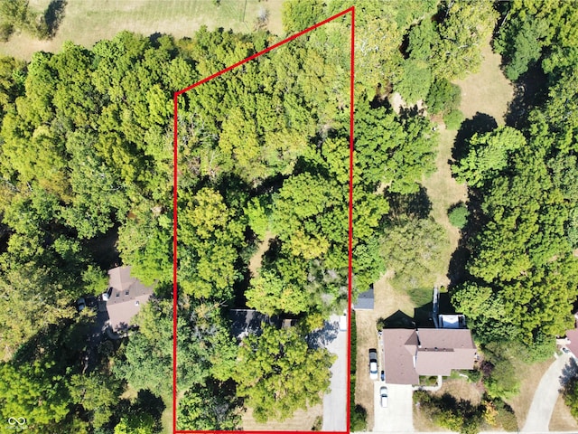 birds eye view of property featuring a wooded view