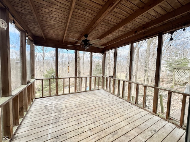 unfurnished sunroom featuring a ceiling fan