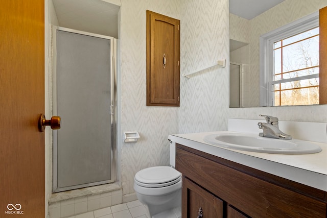 bathroom featuring toilet, a shower stall, vanity, and wallpapered walls