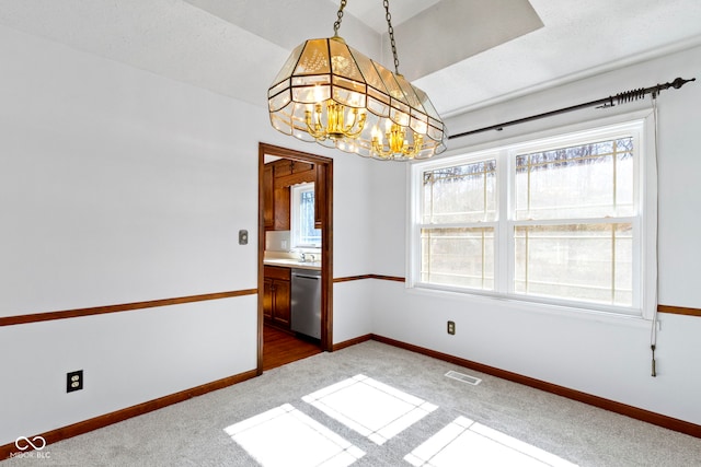 unfurnished dining area with visible vents, baseboards, vaulted ceiling, dark colored carpet, and an inviting chandelier