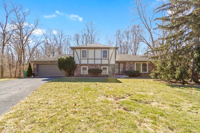 view of front of house with aphalt driveway, a garage, brick siding, stucco siding, and a front yard