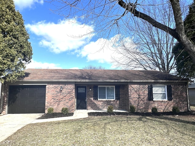 single story home featuring driveway, brick siding, a front lawn, and an attached garage