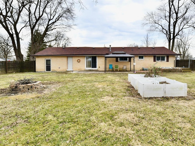 back of property featuring an outdoor fire pit, a lawn, and a fenced backyard