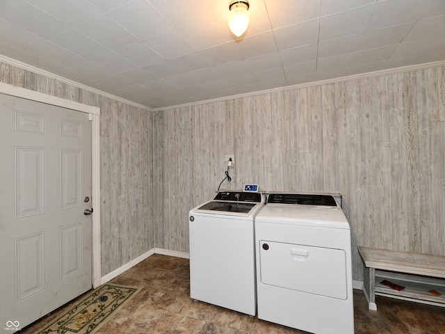 laundry area with ornamental molding, washer and dryer, laundry area, and baseboards