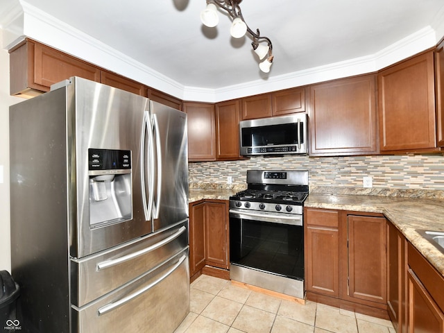 kitchen featuring appliances with stainless steel finishes, tasteful backsplash, brown cabinets, and light tile patterned floors