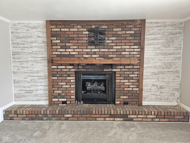 room details featuring baseboards, carpet floors, a fireplace, and crown molding